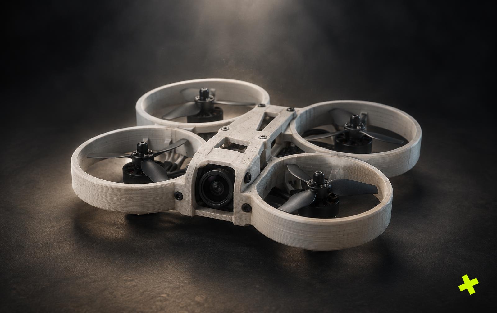 Krijtwitte 3D-geprinte cinewhoop met beschermringen op een donkere studiovloer